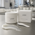 Private label melting balm cleanser jar and carton with LOGO placeholder on a factory sample table