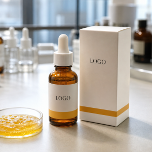 Private label turmeric radiance ampoule serum bottle and carton with LOGO placeholder on a factory sample table